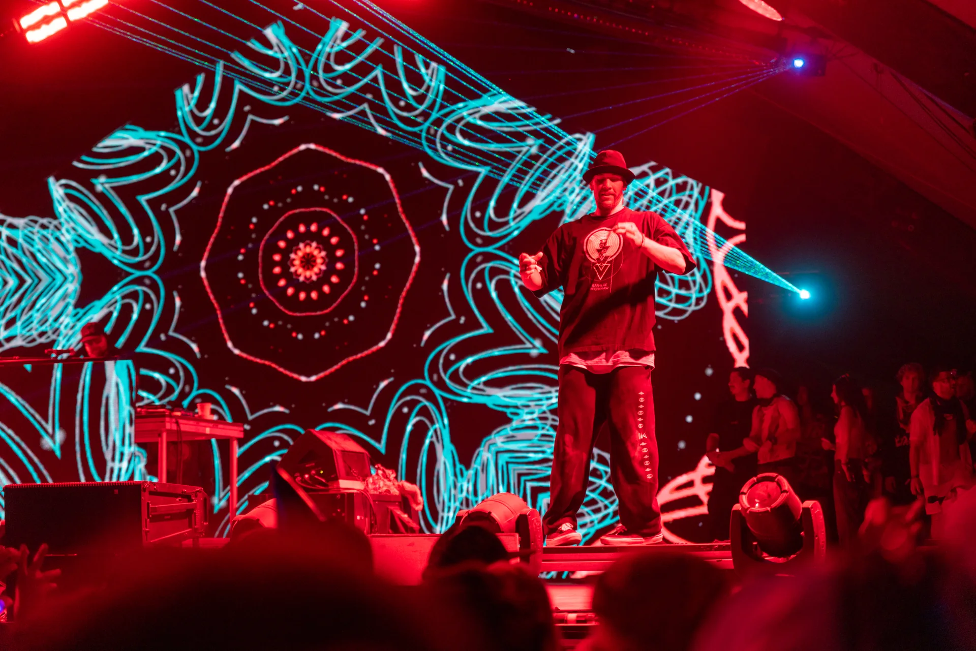 Red and turquoise festival stage lighting around a performer